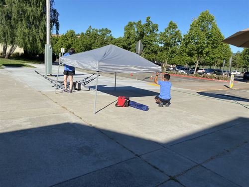 staff setting up canopy